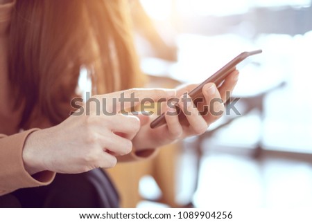 Close up woman hand holding smartphone, She using in mobile applications and multimedia programs. copy space