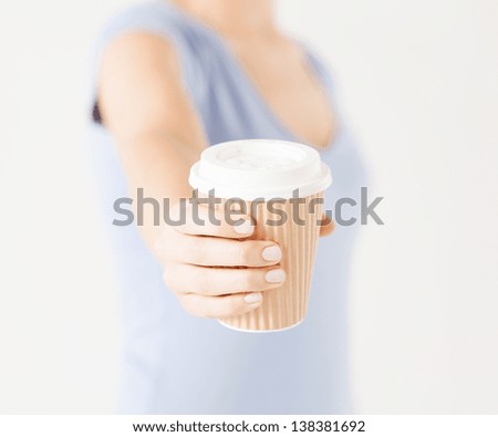 Similar – Image, Stock Photo Hand holding coffee, woman drinking in background