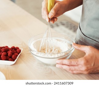Close up Woman Hand Mixed Batter on Clear Bowl with Baloon Whisk Step by Step Baking Preparation in the Kitchen - Powered by Shutterstock
