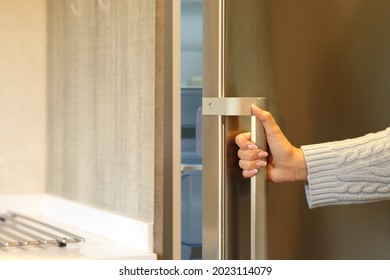 Close Up Of A Woman Hand Opening Fridge Door In The Kitchen