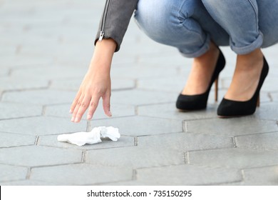 Close Up Of A Woman Hand Picking Garbage Of The Sidewalk On The Street 