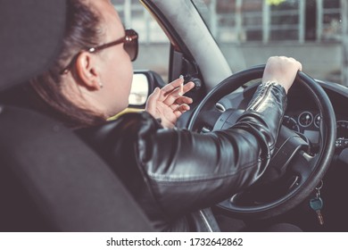 Close Up Of Woman Hand Smoking Cigarette Inside The Car While Driving A Vehicle