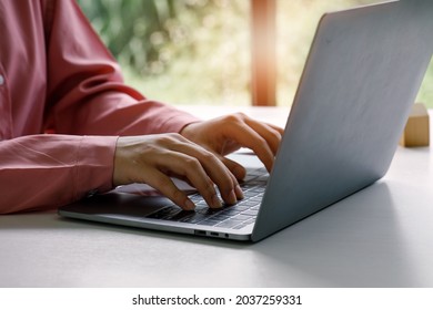 Close up of Woman hand typing on laptop computer keyboard.