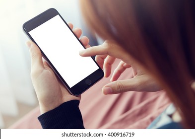 Close Up Woman Hand Using A Smart Phone On  Bed At Home.