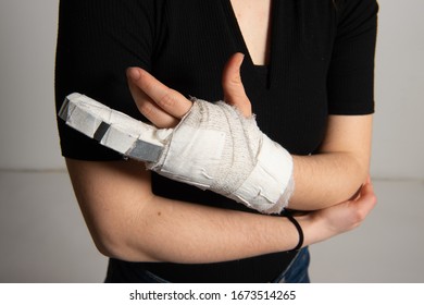 Close Up Of Woman Hand In White Wrist Bandage With Steel Fixation Of Broken Finger. Stress Fracture Or Repetitive Strain Injury In Hand. Accidents And Health Care Concept.
