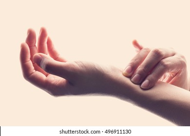 Close Up Woman Hands Checking Heart Rate Pulse On Wrist.