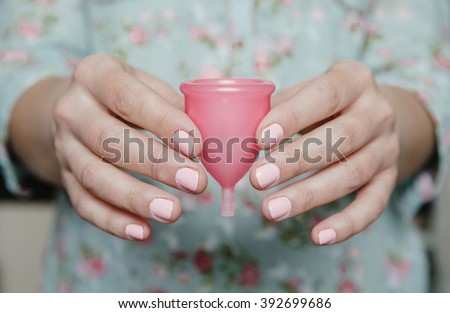 Close up of woman hands holding menstrual cup