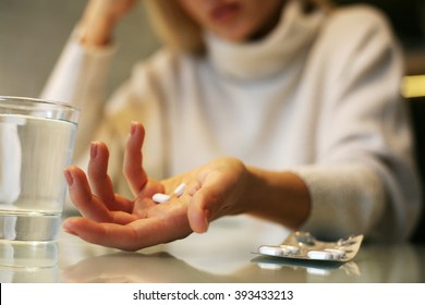 Close up of woman hands holding a pills.  - Shutterstock ID 393433213
