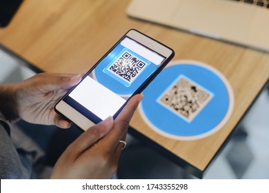 Close Up Woman Hands Holding Smart Phone Scanning QR Code For Payment In Shop.