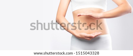 Close up woman hands made protect shape stomach isolated on white background banner size.health care digesting concept.
