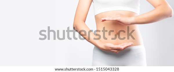 Close up woman hands made protect shape stomach\
isolated on white background banner size.health care digesting\
concept.