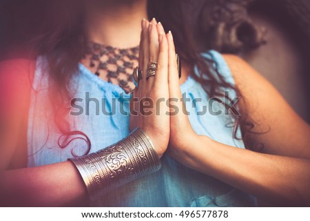 close up of woman hands in namaste gesture outdoor shot 