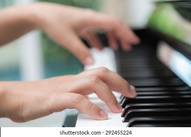 Close up of woman hands  playing piano