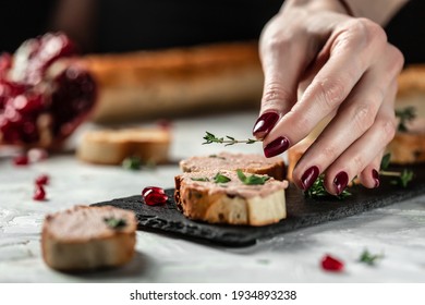 Close Up Woman Hands Preparing And Eating Gourmet Belgian Duck Liver Pate Bread. Fresh Homemade Chicken Liver Pate On Toasted Bread With Greens And Pomegranate. Place For Text.