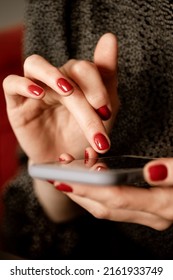 Close Up Woman Hands With Red Nail Polish Manicure Holding Mobile Phone And Texting