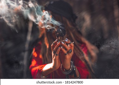 close up of woman hands with shamanic fire outdoors