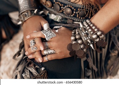 close up of woman hands with stylish boho accessories
