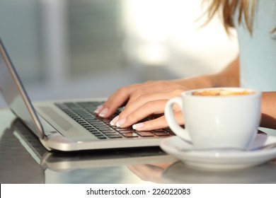 Close Up Of A Woman Hands Typing In A Laptop In A Coffee Shop Terrace In The Street