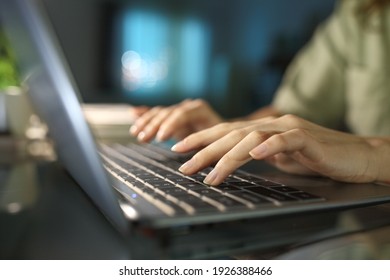 Close up of a woman hands typing on laptop keyboard in the night at home - Shutterstock ID 1926388466