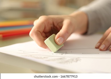 Close Up Of Woman Hands Using Rubber Erasing Pencil Drawing On A Desk At Home