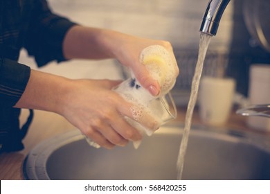 Close Up Of Woman Hands Washing Dishes.