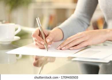 Close Up Of Woman Hands Writing A Letter Sitting On A Desk At Home