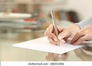 Close Up Of Woman Hands Writing Letter On Paper Sheet On Glass Table At Home