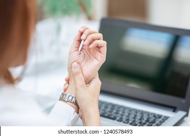 Close up woman have a Carpal Tunnel Syndrome or wrist pain after work hard in office feeling so pain and illness with Office syndrome symptom,Healthcare Office Syndrome Concept,Selective Focus
