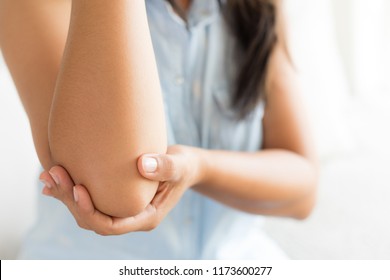 Close Up Woman Having Pain In Injured Elbow. Health Care And Arm Pain Concept.