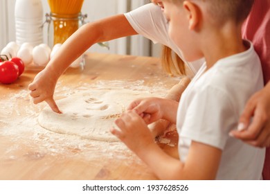 Close Up Of Woman With Her Child Kneading Dough