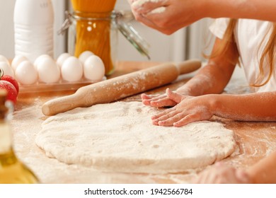 Close Up Of Woman With Her Child Kneading Dough