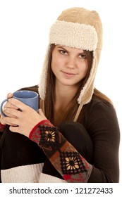 A Close Up Of A Woman In Her Warm Hat And Long Johns Holding A Warm Cup Of A Drink.