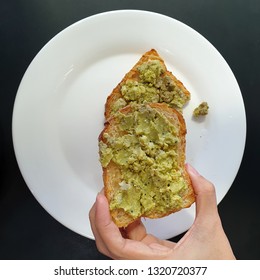 Close Up Of Woman Holding Avocado Toast As Fresh Snack