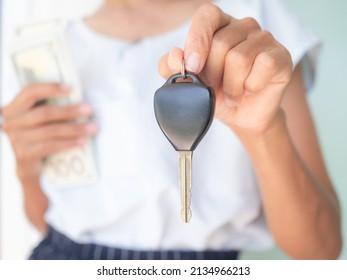 Close Up Woman Holding Car Keys Blur Holding Bank Note. Borrow Money Credit. Car Loan. Problem Cash In Family. Plan Expenses And Income For 2023 New Year. Business Or Finance Concept.