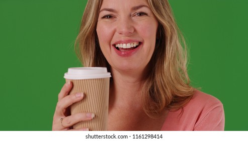 Close Up Of Woman Holding Coffee Or Tea Smiling At Camera On Green Scree