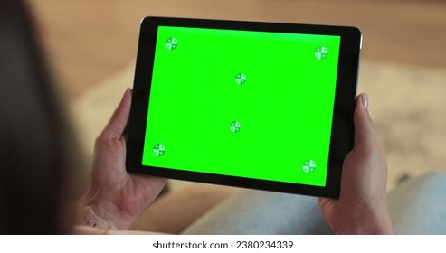 Close up of woman holding a digital tablet with green screen. Internet online, chroma key screen concept. - Powered by Shutterstock