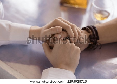 Close up woman and woman holding hands. Girlfriend and boyfriend having honest talk, declaring in love during date, loving girl comforting, express psychological support showing empathy to beloved guy