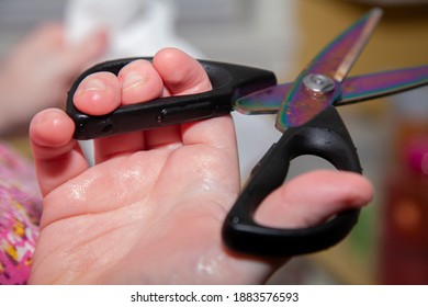 Close Up Of A Woman Holding Kitchen Shears