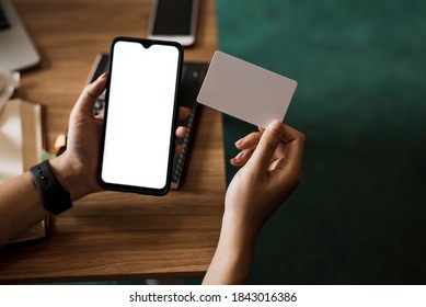 Close Up Woman Holding Mobile Phone With A White Screen And Credit Card. Online Shopping Concept