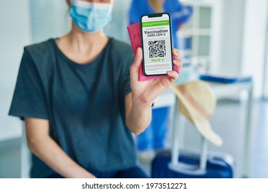 Close Up Of Woman Holding Phone With Digital Vaccination Card