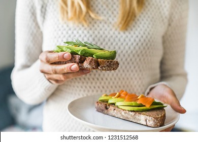 close up of woman holding plate with avocado toast as fresh snack, day light. - Powered by Shutterstock