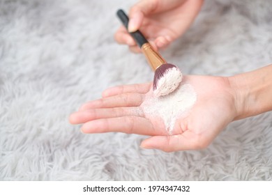 Close Up Woman Holding Talc Make Up And Brush On Carpet Background, Beauty Concept.