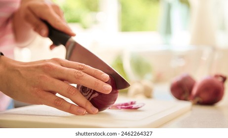 Close Up Of Woman At Home Preparing Meal In Kitchen Slicing Red Onion On Chopping Board - Powered by Shutterstock