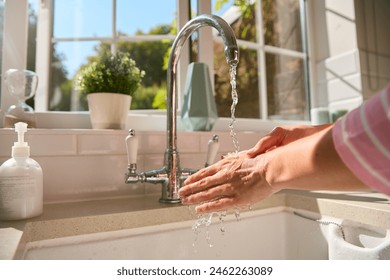 Close Up Of Woman At Home Washing Hands In Kitchen Sink - Powered by Shutterstock