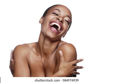 Close up of a woman laughing and hugging herself