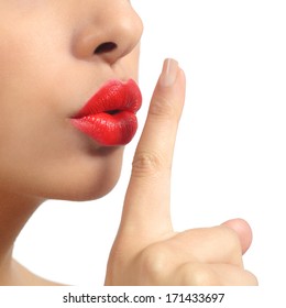 Close up of a woman lips with finger asking for silence isolated on a white background             