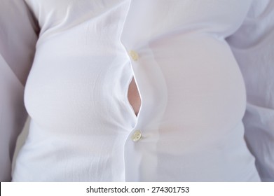 Close Up Of A Woman With Little Shirt For Being Fat