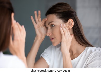 Close Up Of Woman Looking In Mirror Check Face After Mask Cream Beauty Treatment Feels Satisfied Admire Reflection, Laser Skin Resurfacing, Glycolic Acid Peel, Anti-ageing Skincare Procedures Concept