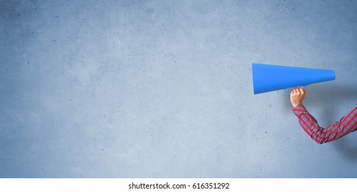 Close of woman making announcement in paper trumpet - Shutterstock ID 616351292