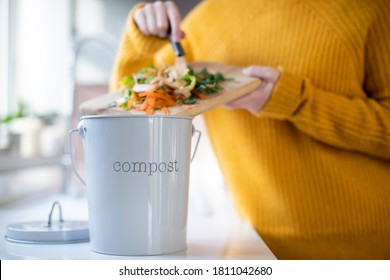 Close Up Of Woman Making Compost From Vegetable Leftovers In Kitchen - Powered by Shutterstock